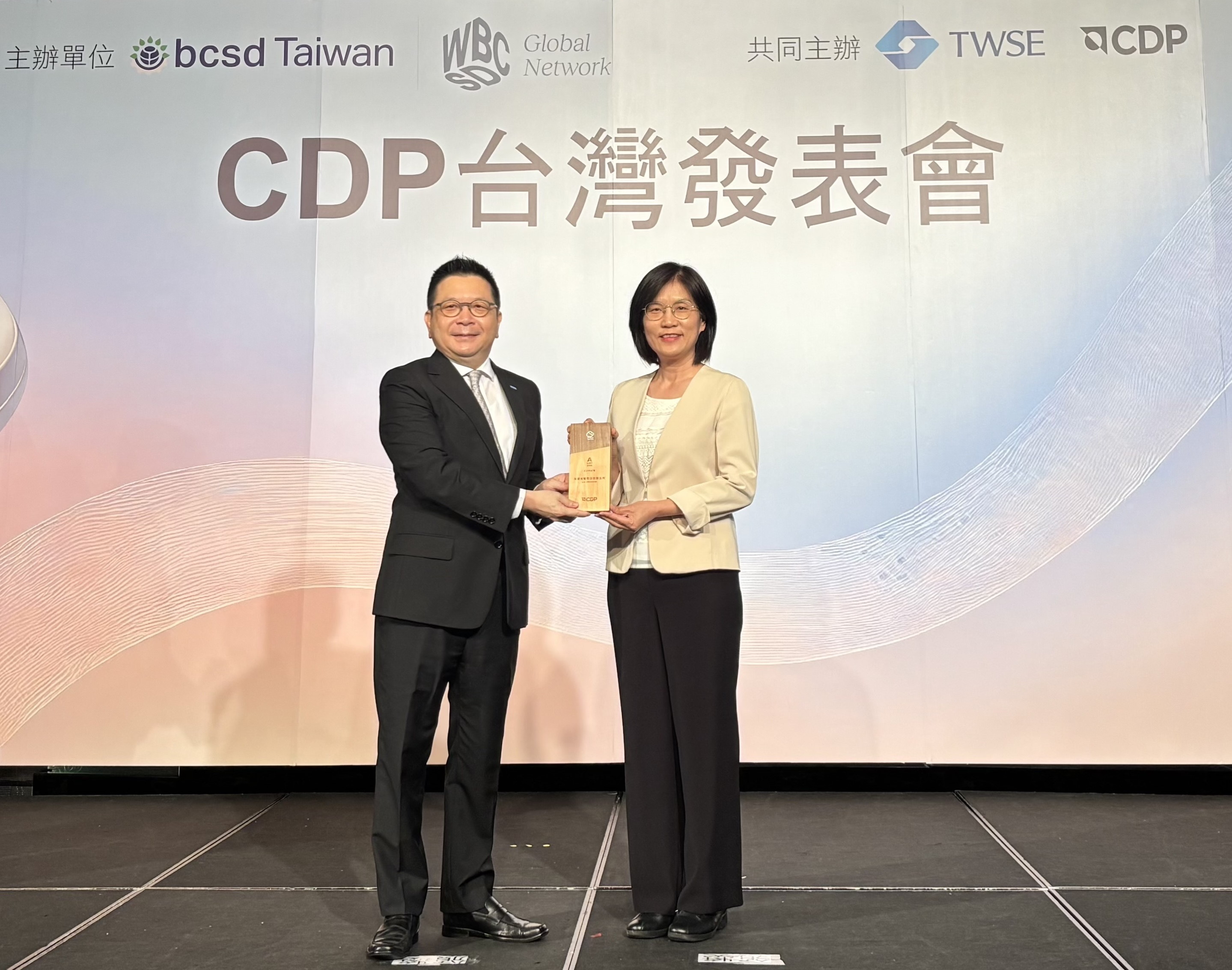 友達永續成果再獲國際評比肯定，獲頒CDP氣候與水資源雙項領導力評級。今由臺灣證券交易所董事長林修銘（左）頒獎，友達光電永續長古秀華（右）代表受獎